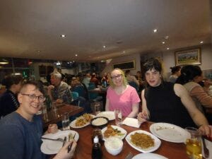 Picture of TPATH attendees having dinner at M&L Szechuan Chinese restaurant in Dublin. 4 people are seated around a table and there is a lot of food on it.