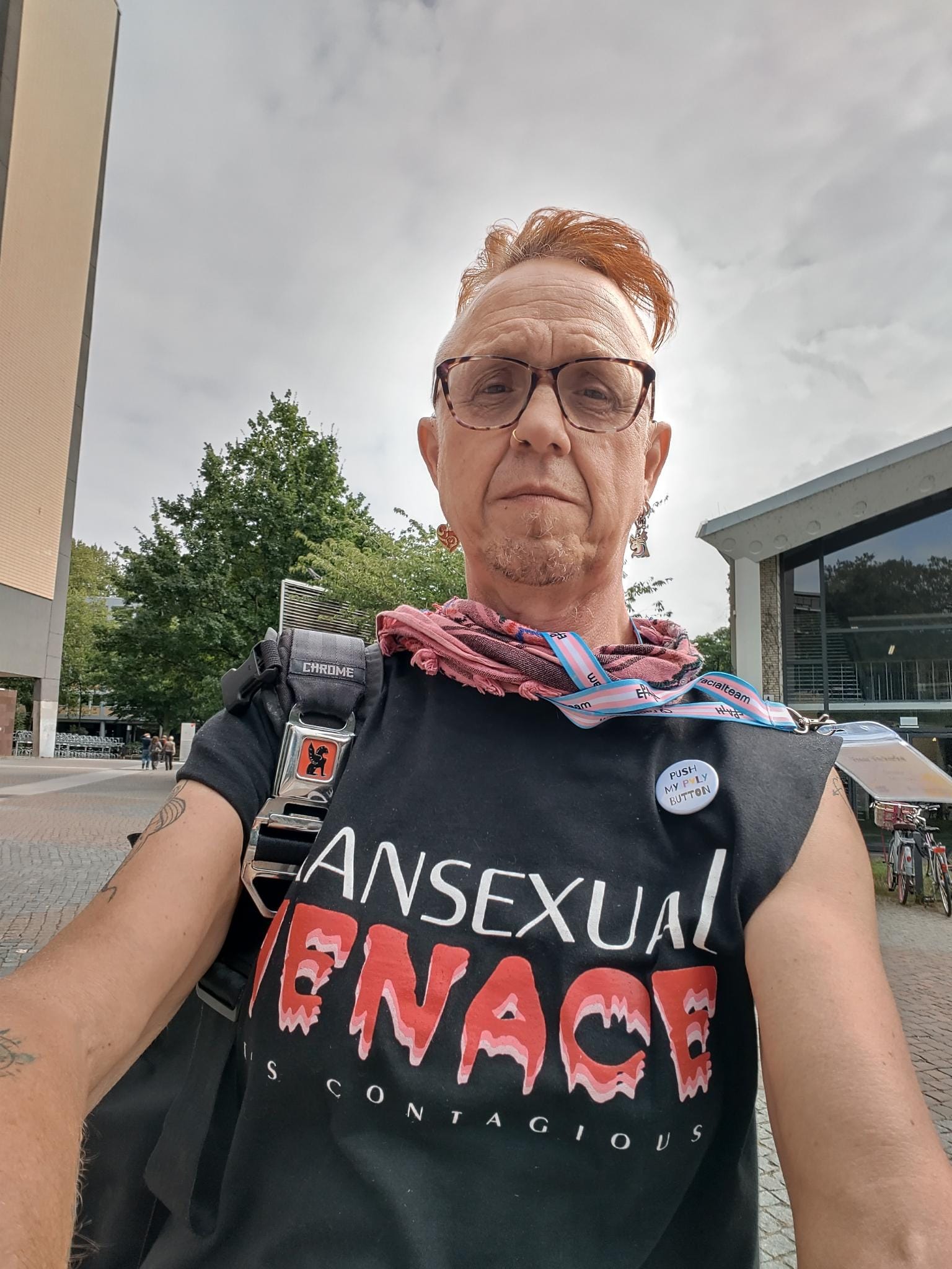 Picture of vreer verkerke wearing a black sleeveless t-shirt that reads Transsexual Menace.