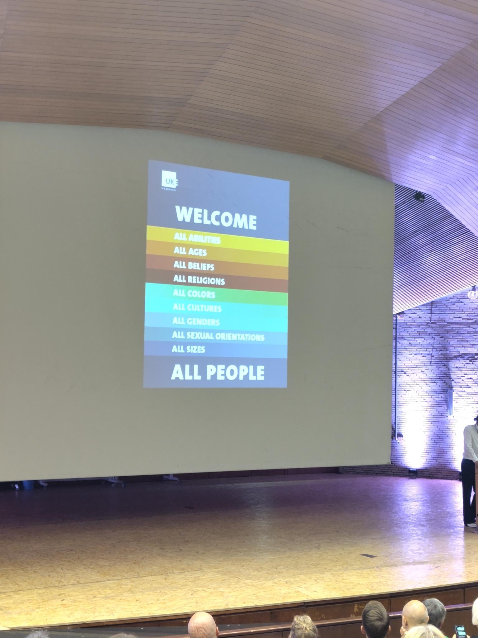 Conference welcome slide that reads, we welcome all abilities, ages, beliefs, religions, colors, cultures, genders, sexual orientations, sizes, and people.